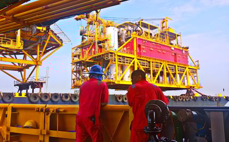 Offshore workers in safety gear on drilling platform