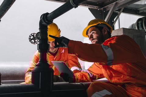 Professional engineers performing service maintenance on industrial equipment